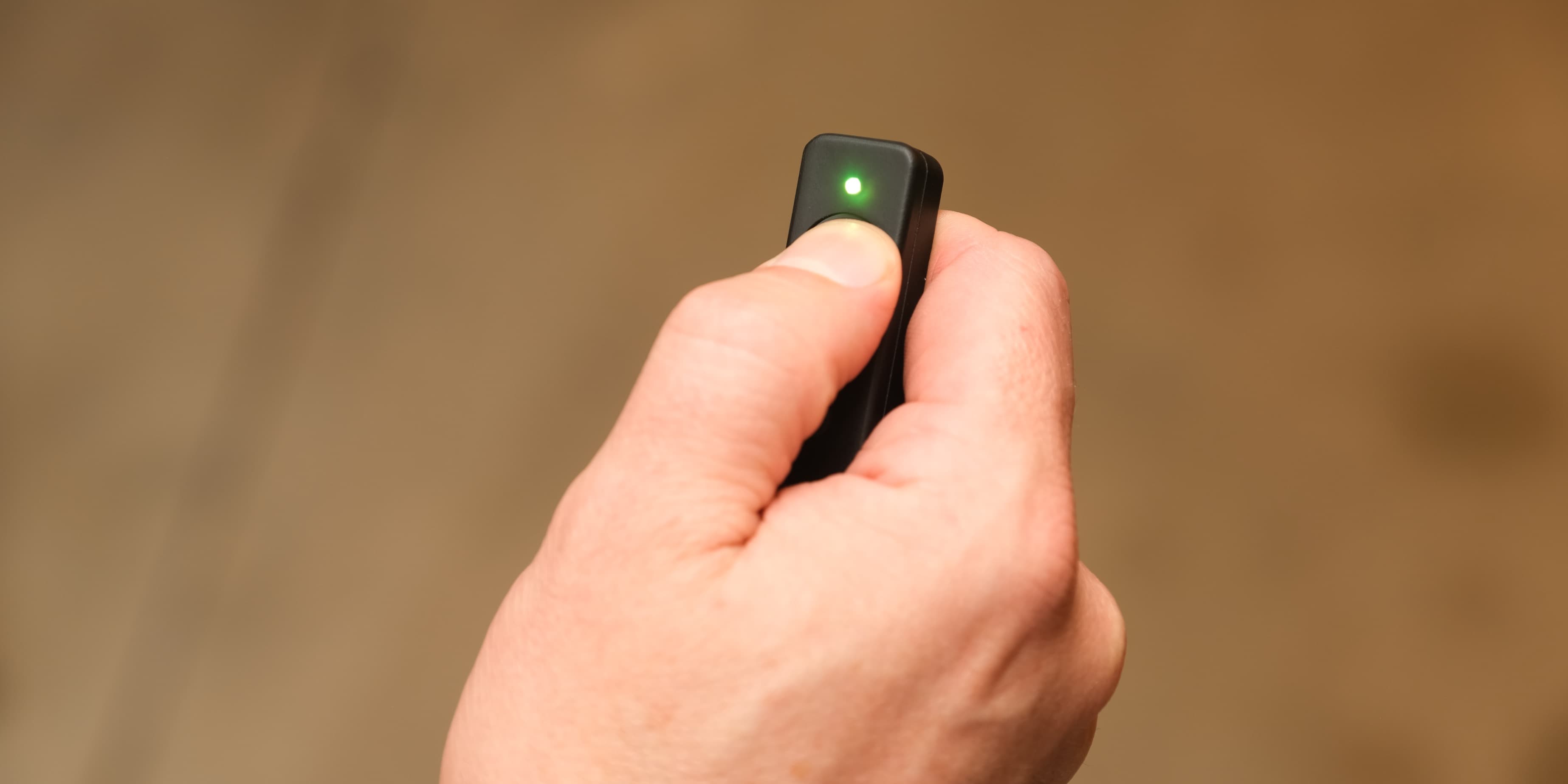 Thumb pressing the Marker Maker TX button, green LED confirming the mark